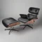 Full front view of the lounge chair charles eames and ottoman set in black aniline leather.