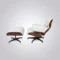 Front view of lounge chair charles and ray eames featuring hand-sewn white leather cushions and black swivel base.