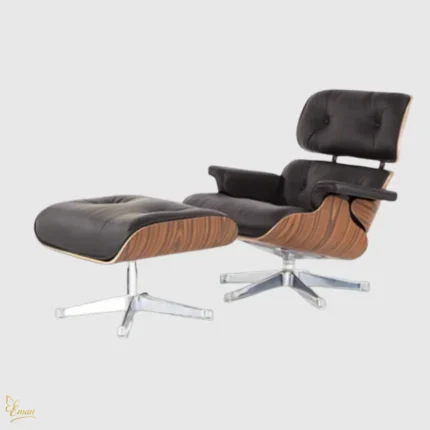 Angled view of the iconic Mid-Century Eames lounge chair set with brown leather cushions and a swivel chrome base.