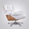 The back and profile of an ash wood eames chair lounge chair with a white leather interior and chrome hardware.